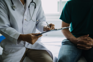 Male patient having consultation with doctor or psychiatrist who working on diagnostic examination on men's health disease or mental illness in medical clinic or hospital mental health service center