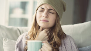 Young woman suffering from Aching jaw sore throat