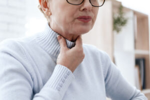 woman with aching jaw sore throat